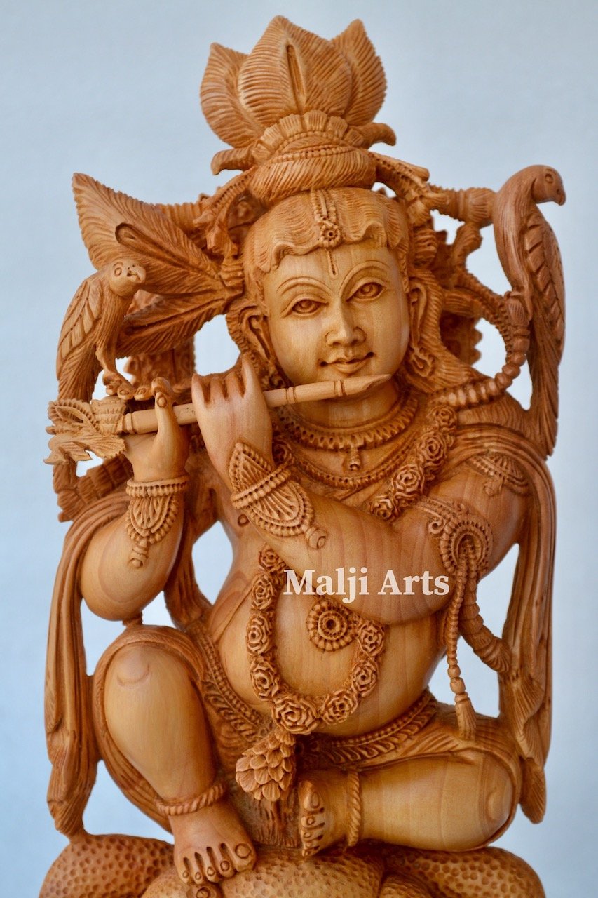 Baby Krishna sitting on snack fine wooden hand carved statue - Malji Arts