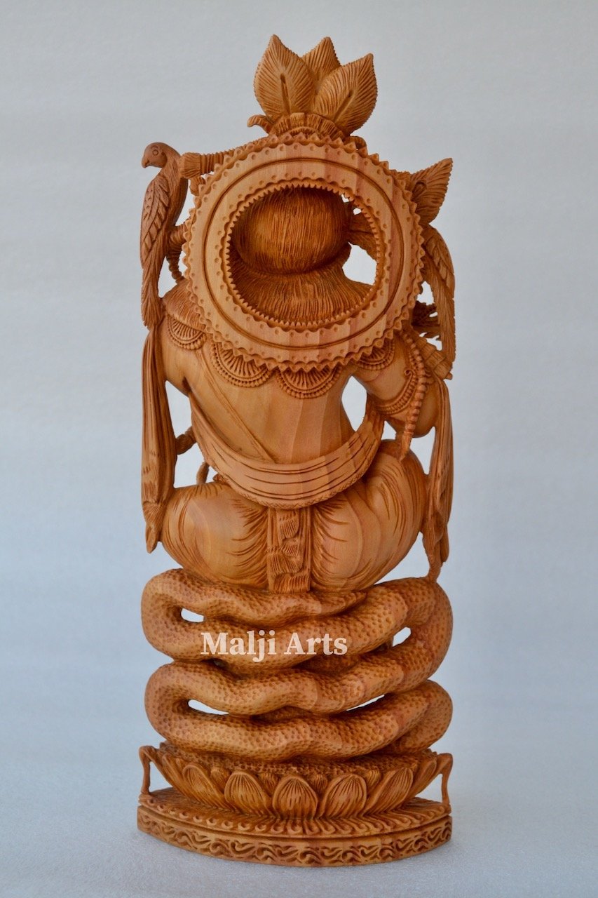 Baby Krishna sitting on snack fine wooden hand carved statue - Malji Arts