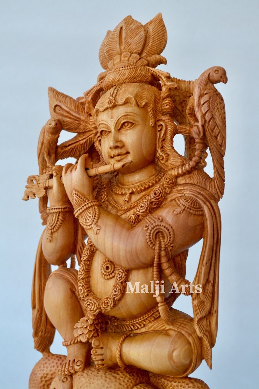 Baby Krishna sitting on snack fine wooden hand carved statue - Malji Arts
