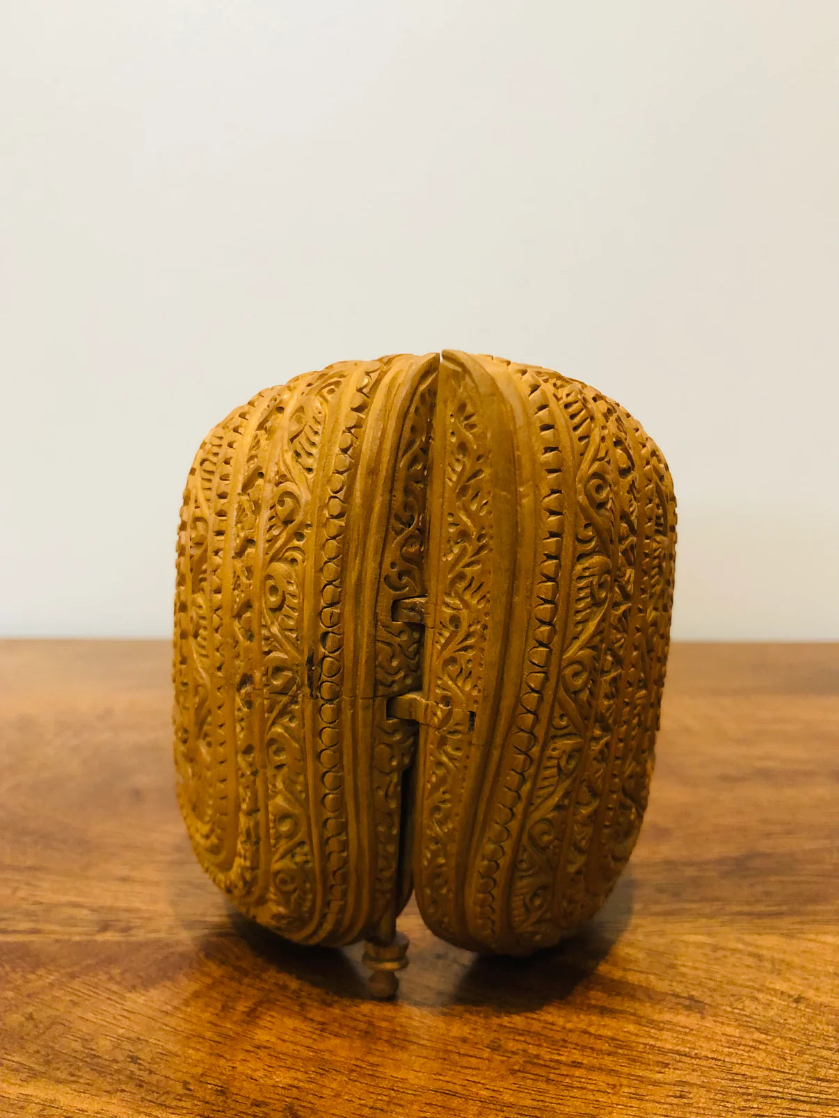 Sandalwood carved god inside shell - Malji Arts