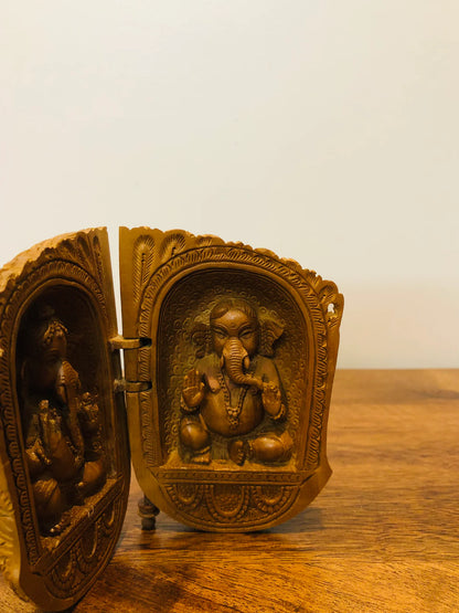 Sandalwood carved god inside shell - Malji Arts