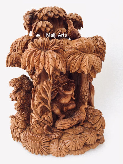 Sandalwood Baby krishna under tree playing flute - Malji Arts