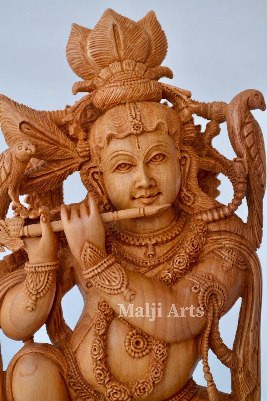 Baby Krishna sitting on snack fine wooden hand carved statue - Malji Arts