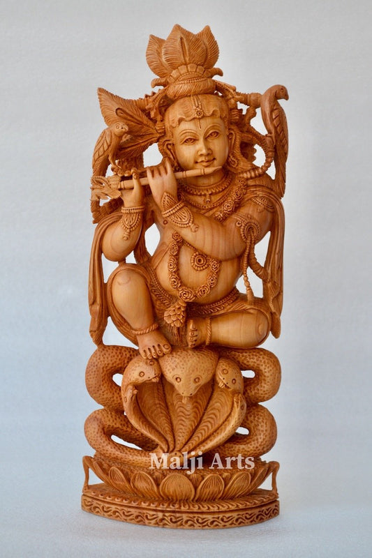 Baby Krishna sitting on snack fine wooden hand carved statue - Malji Arts