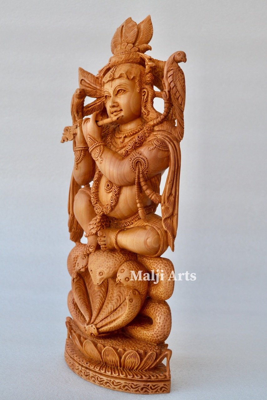 Baby Krishna sitting on snack fine wooden hand carved statue - Malji Arts