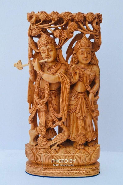 Wooden hand carved radha krishna jodi under tree - Malji Arts
